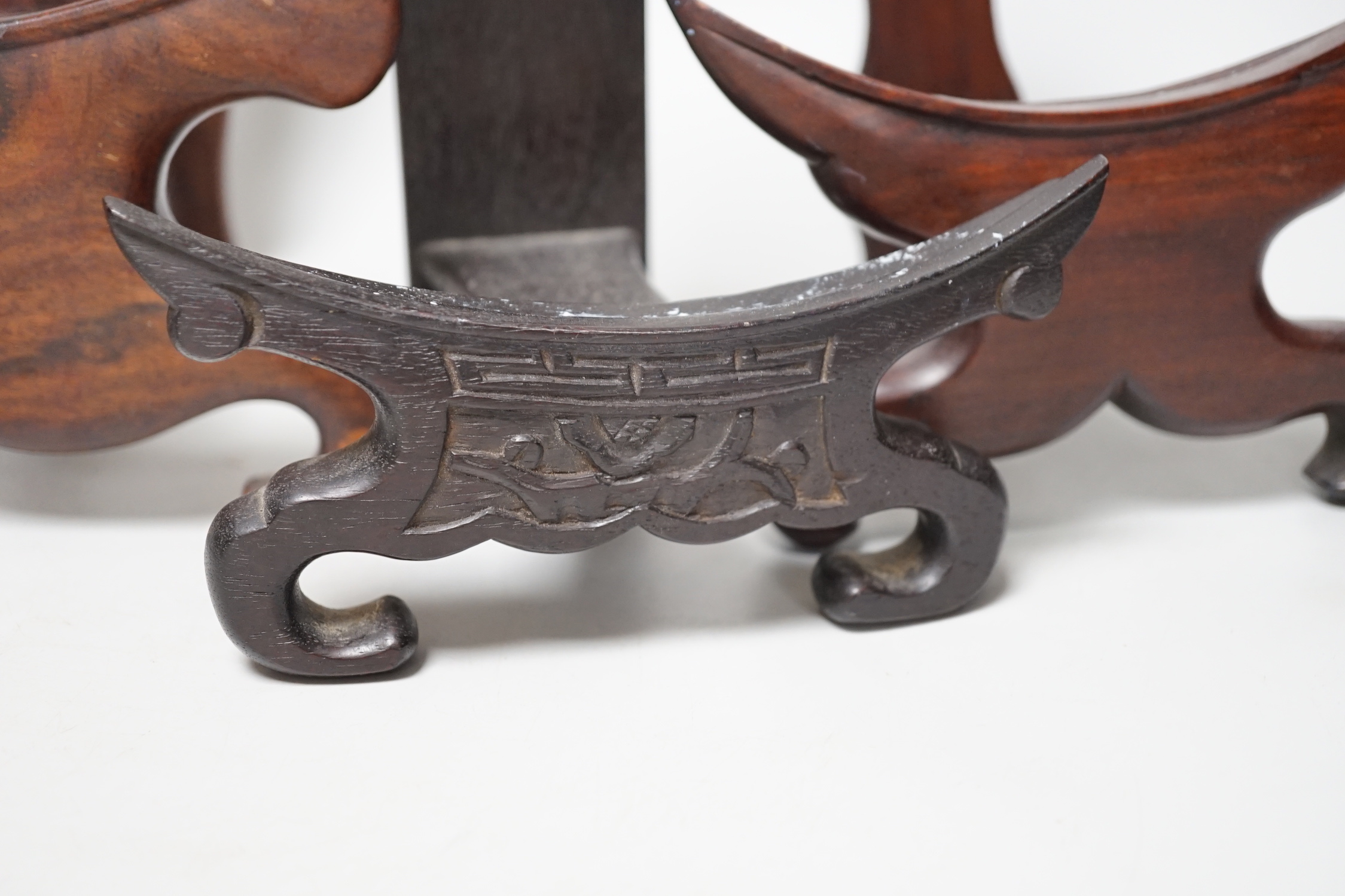 Four Chinese hardwood wood plate or dish stands, tallest 33cm